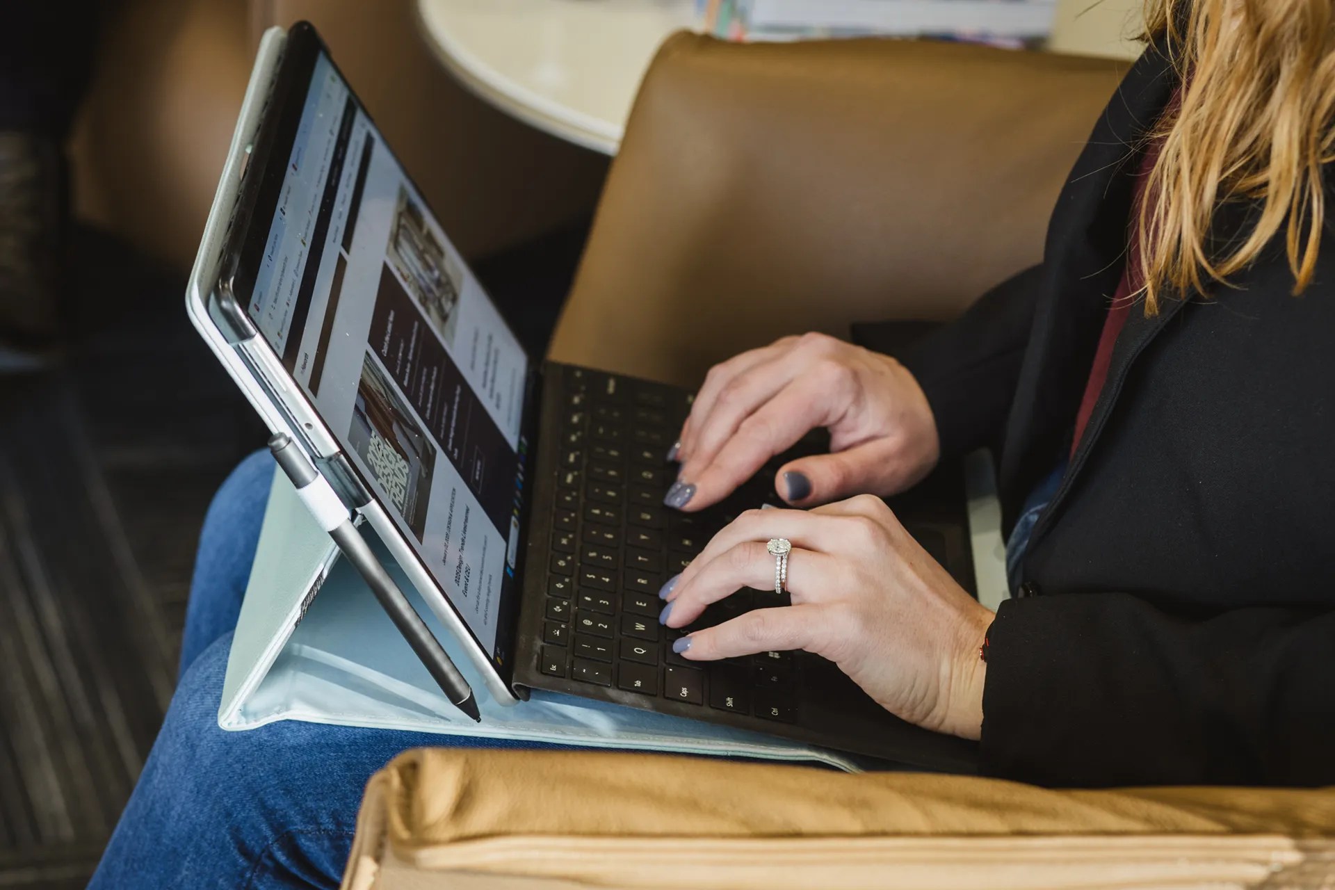 Business professional researching commercial office furniture solutions on a tablet in a modern workspace.