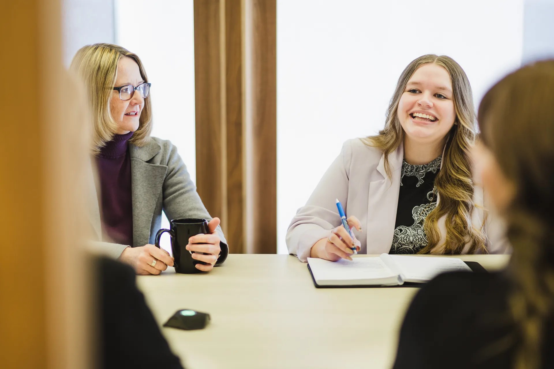 Canfield design team collaborating in a modern office meeting, planning tailored commercial interiors.