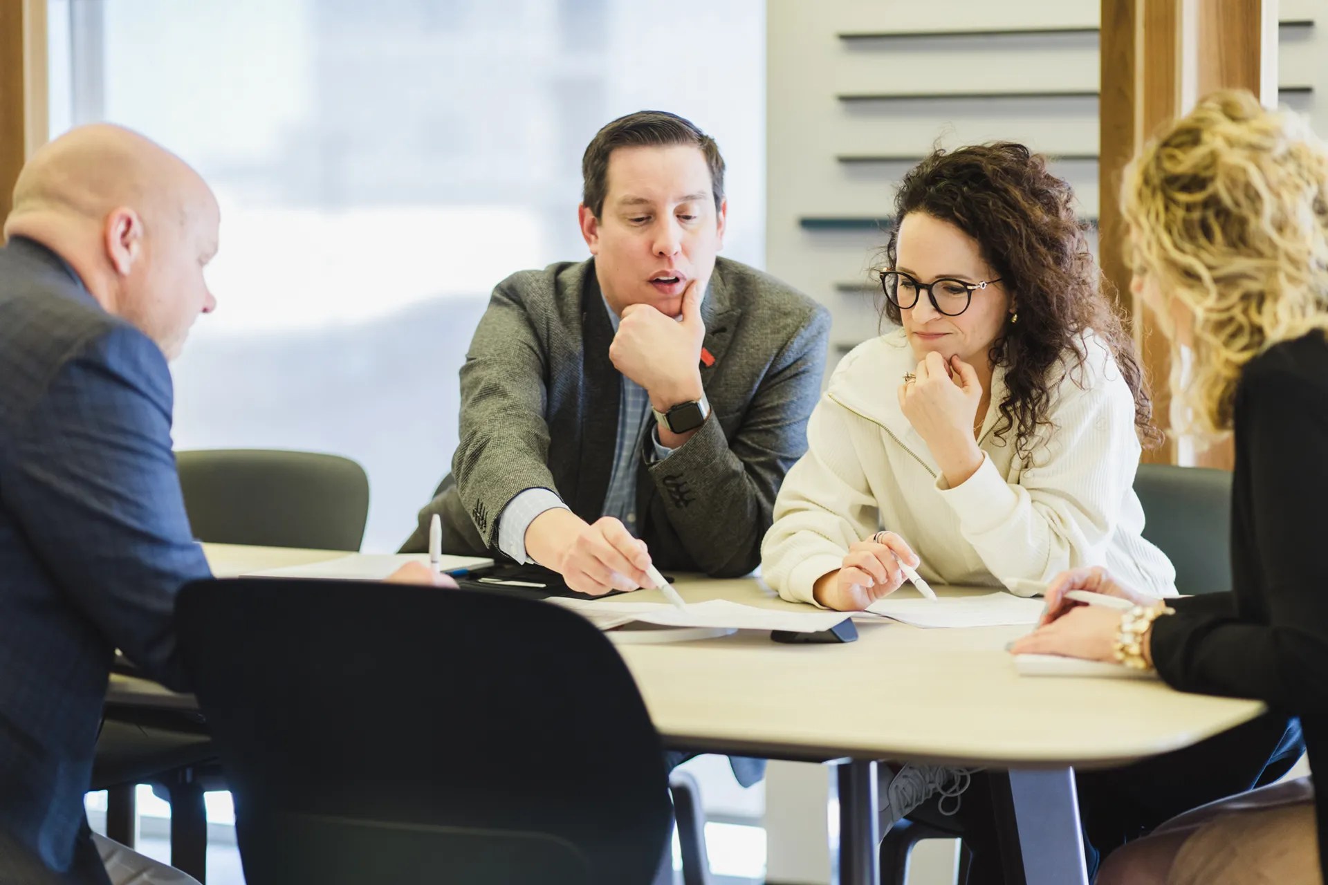 Sales consultant discussing custom commercial furniture options with a client during a design meeting.