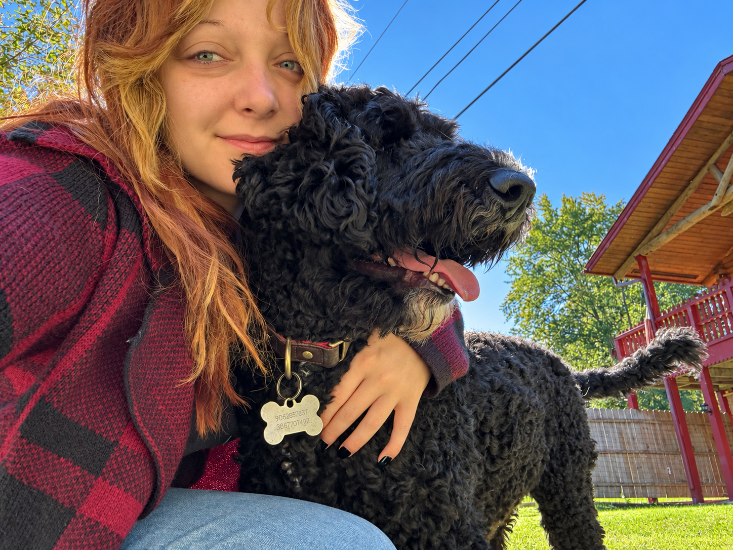 Lauren cuddling a dog outside the cabin