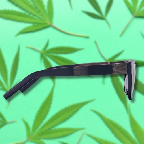 side view of smoking shades on a green background with weed leaves