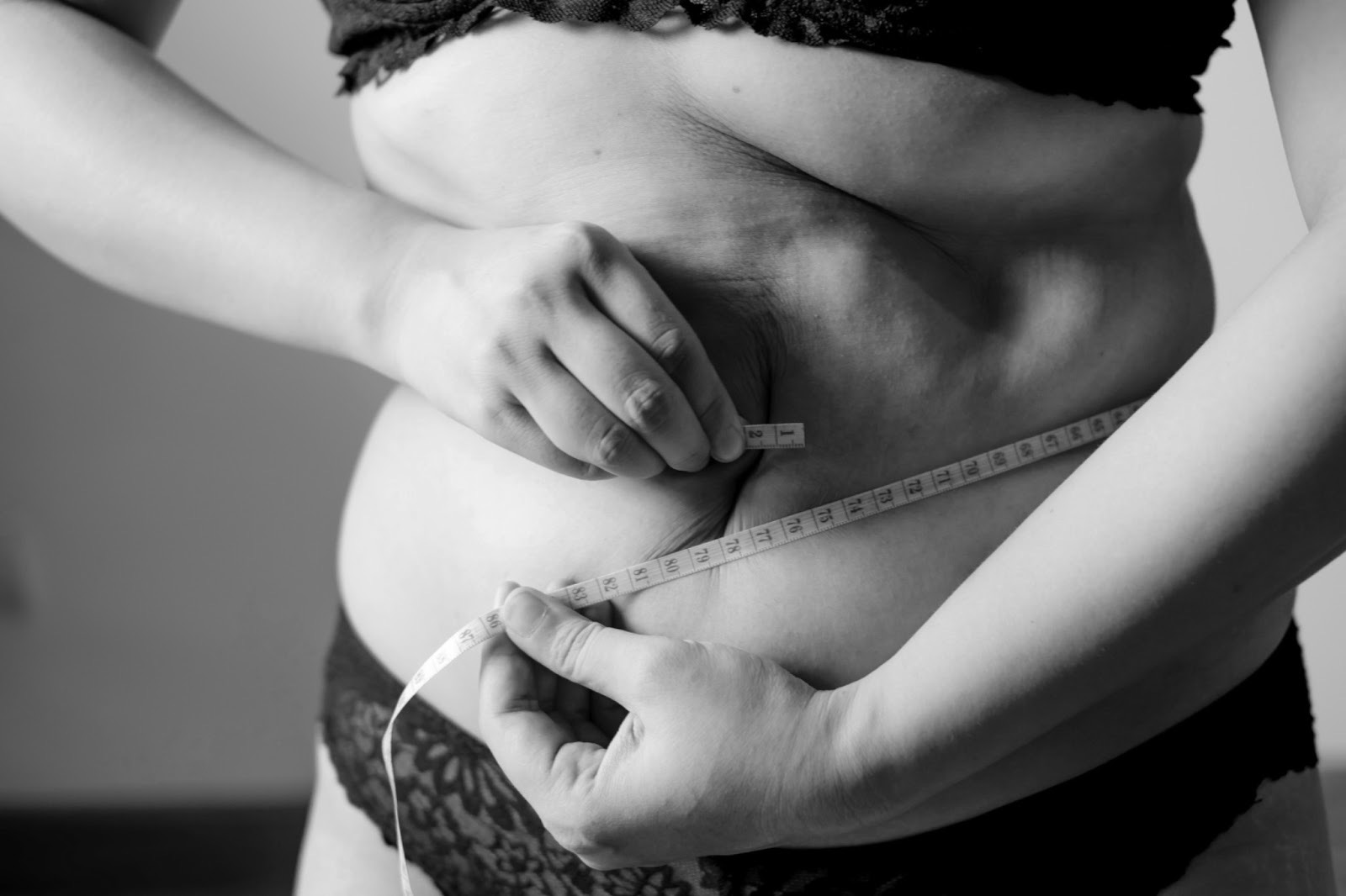 Black and white image of waist measuring. Meant to represent body positivity.