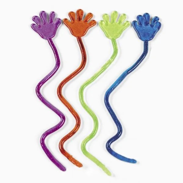 Pega Tazos, acessório para capturar Tazos colecionáveis, é uma maozinha de borracha com uma longa corda também de borracha pegajosa, onde arreneça ela esticando pra pegar tazos