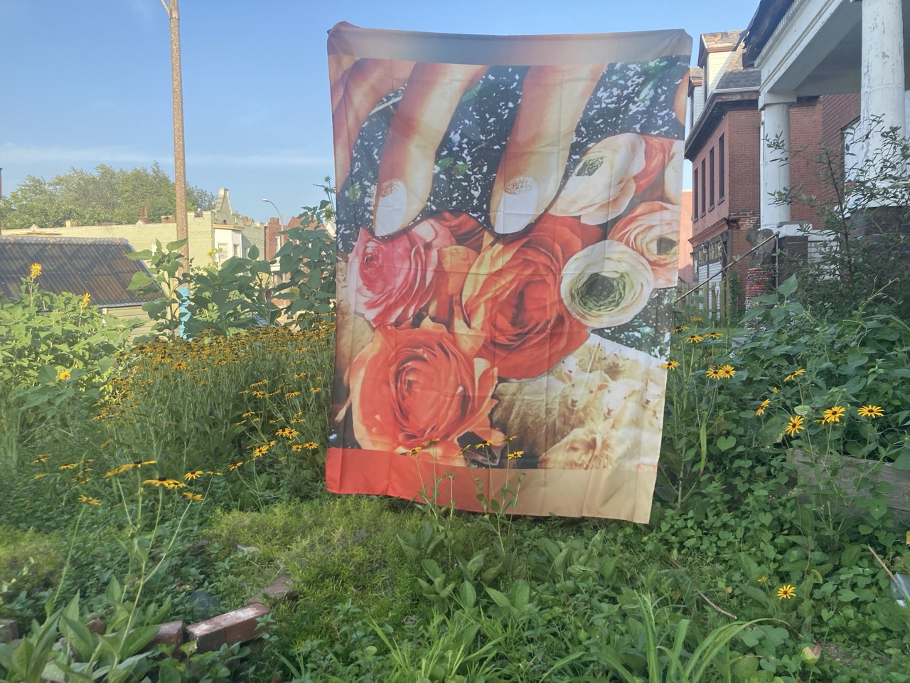 One of artist Dail Chamber's collage installations sits in front of her urban farm in St. Louis.