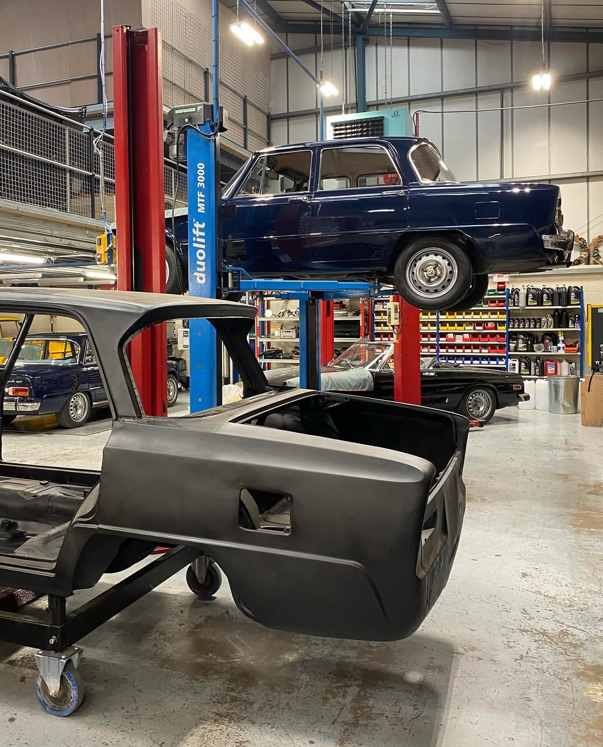 Alfa Romeo Giulia Super on a ramp in a workshop