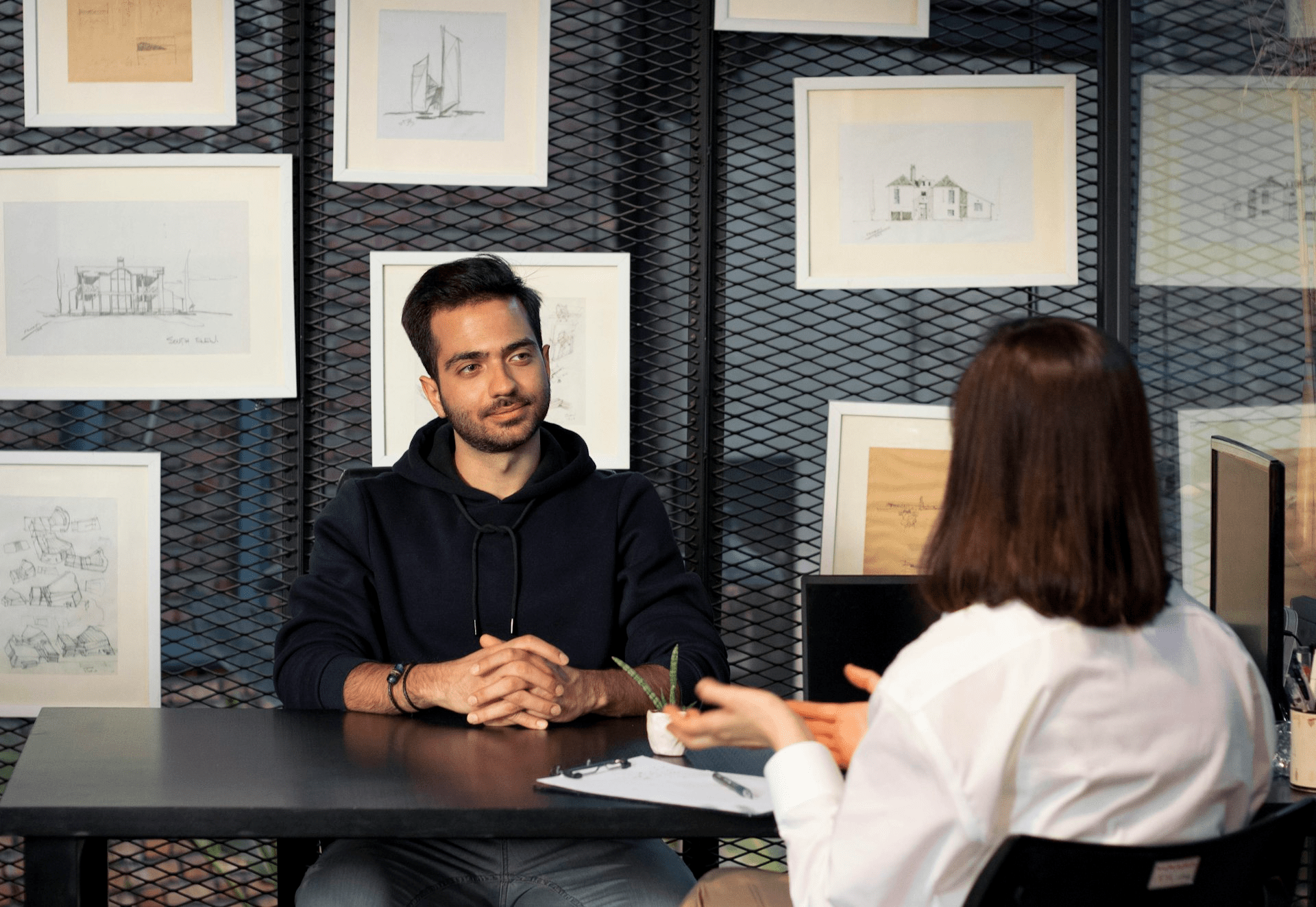 A man and a woman sitting at a table in conversation