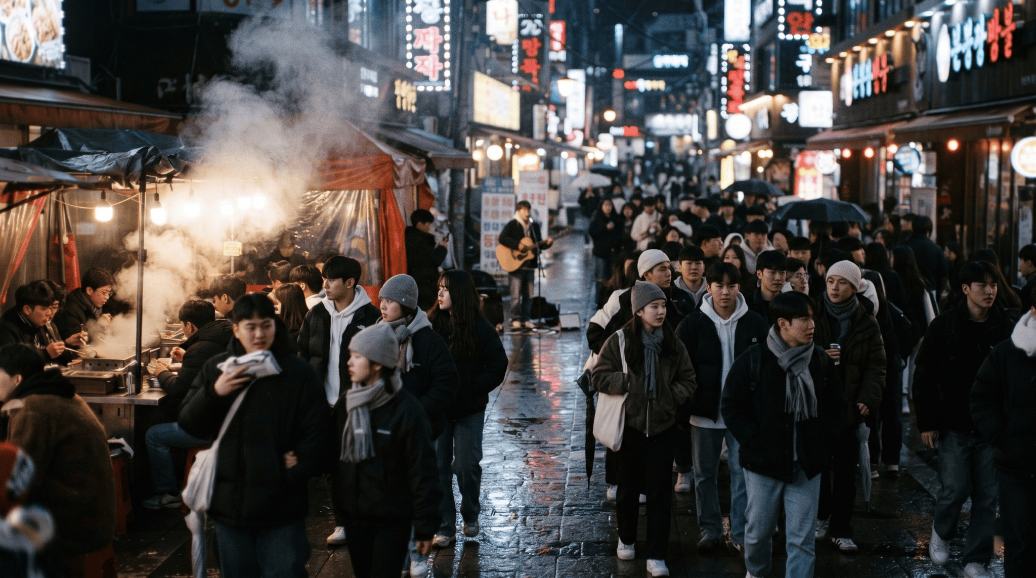 A busy street in Hongdae, Seoul, late on a Saturday night: groups of young men and women walking, street food stall steam, a busker in the distance, neon reflections on wet pavement, signs too blurred to read.