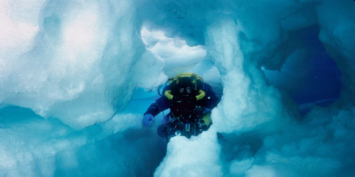 Photos show what cave divers discovered when they swam inside an iceberg the size of Jamaica. Today, it’s gone.