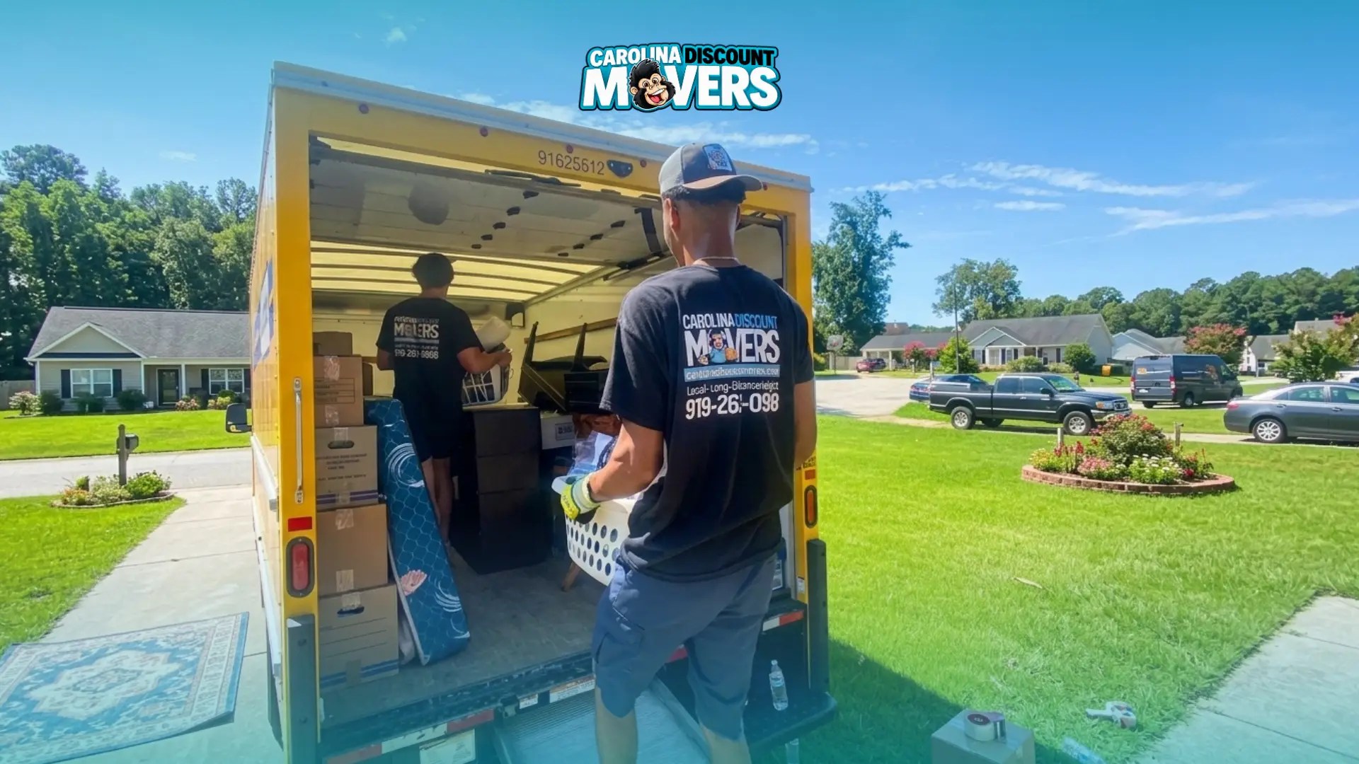 Professional movers helping a homeowner move into a Raleigh-area home after closing