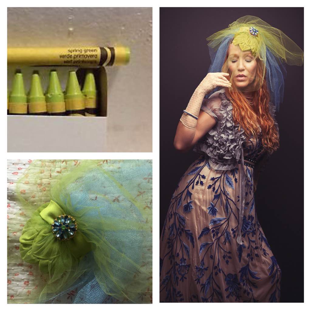 Author CC Hart who has long red hair is wearing a spring green fascinator type hat with layers of spring green and cornflower blue tulle. She is attired in a beige gown that has cobalt blue embroidered flowers over the bodice and skirt. Carolyn CC Hart is an author, artist, and neurodiversity advocate. She has the neurodiverse trait synesthesia, which gives colors to all of her letters. For CC Hart the word spring as it applies to the season is bright green.