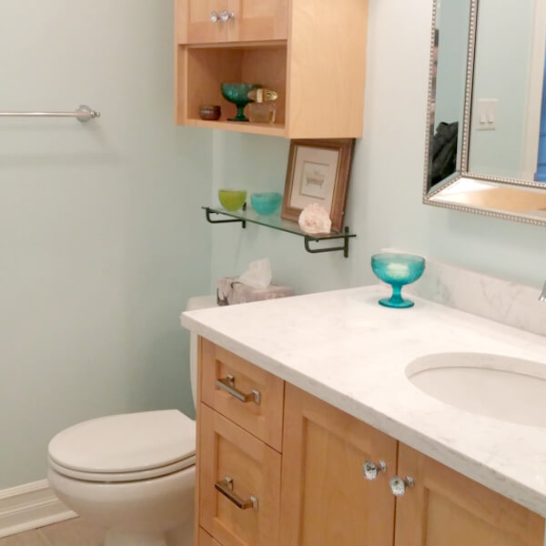 clean white marble vanity with blue glass accent tiles