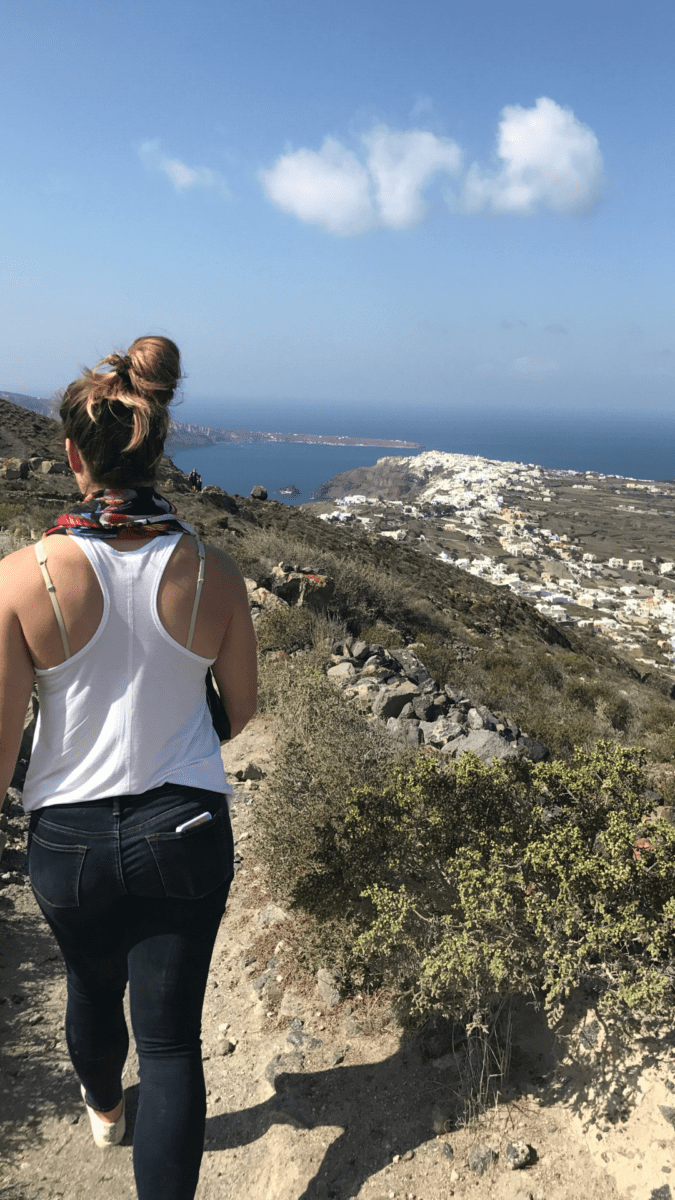 girl hiking to oia santorini