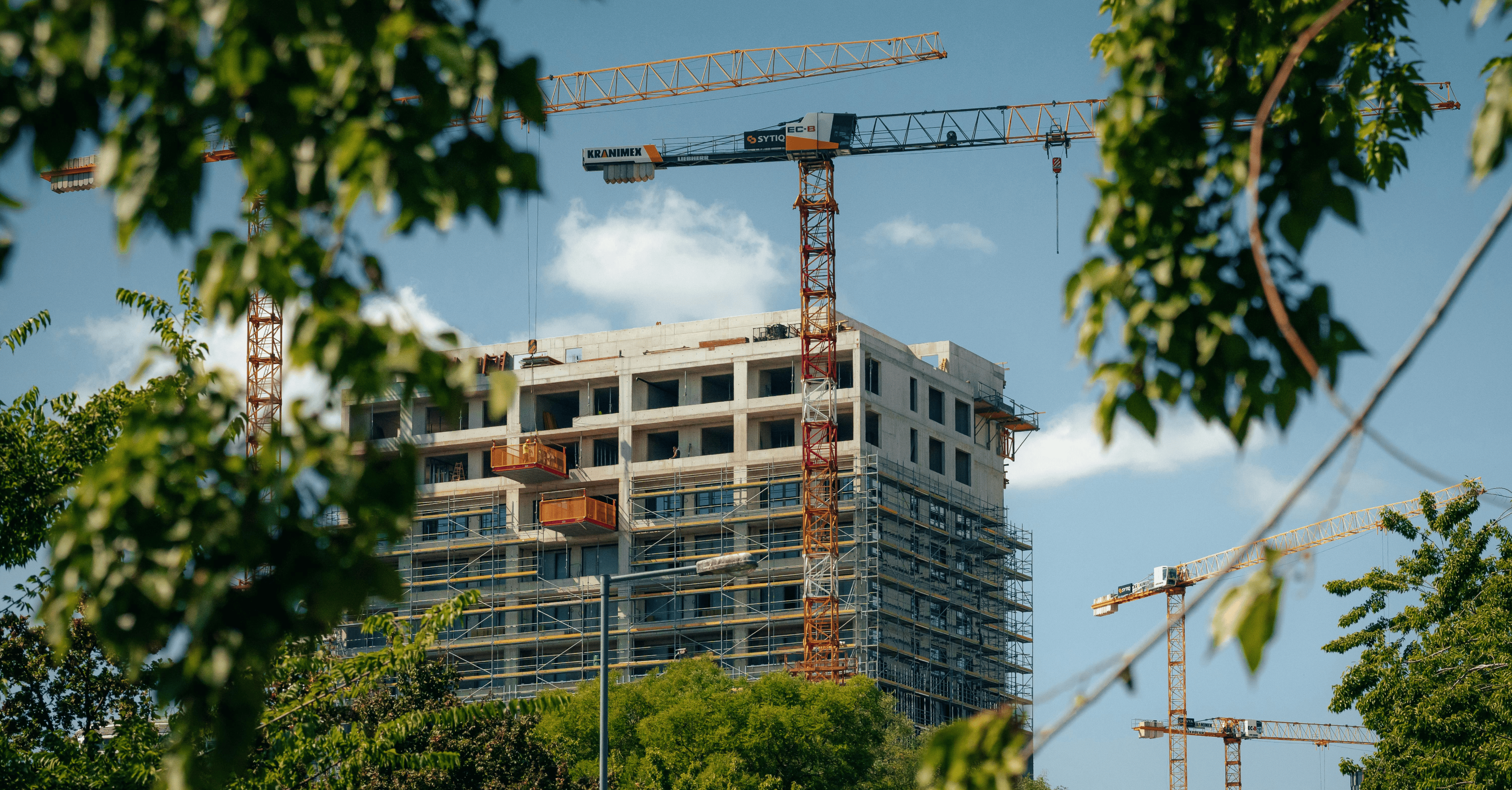 Multi-storey construction site with tower cranes and scaffolding in Queensland, illustrating what casual construction workers cost to put on site