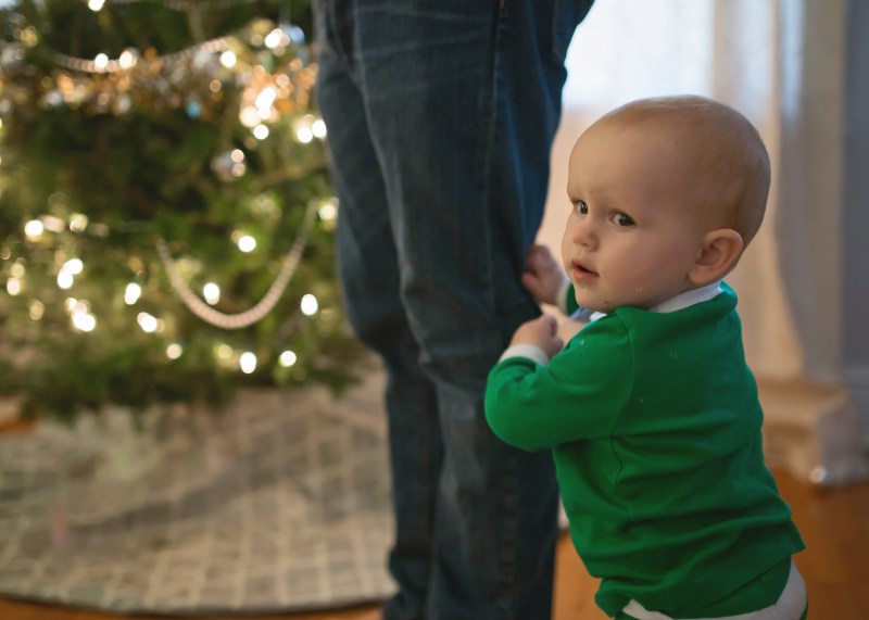 cute baby boy decorating christmas tree