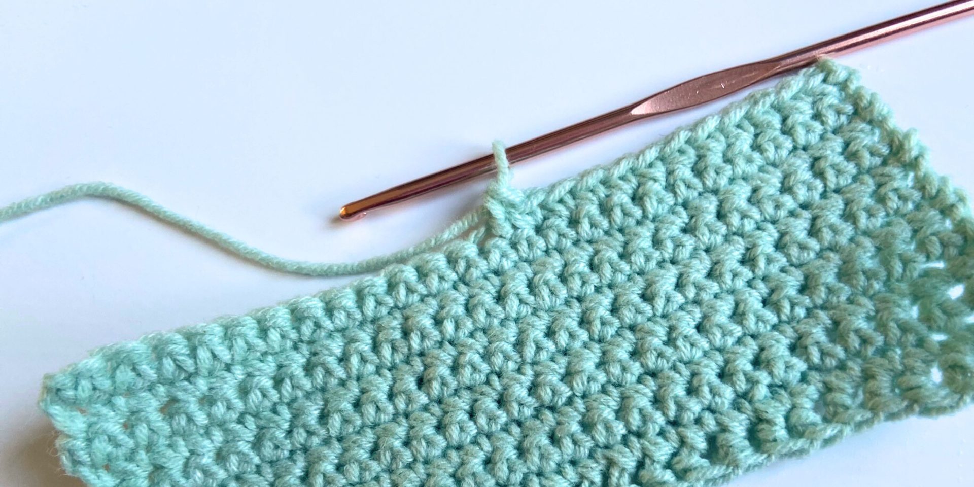 crochet sample with hook showing single crochet stitches and invisible decrease