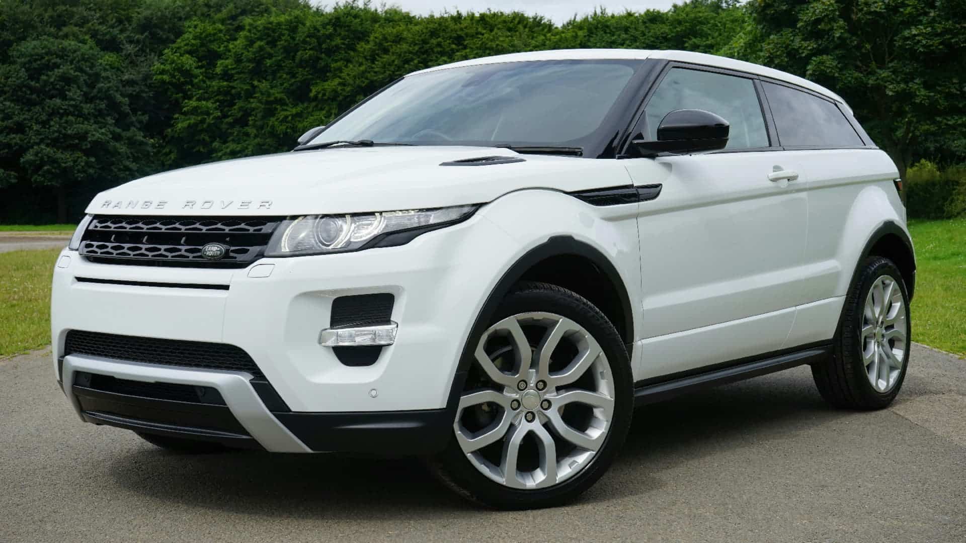 White Range Rover with front catalytic converter parked outdoors - Catman catalytic converter manufacturer