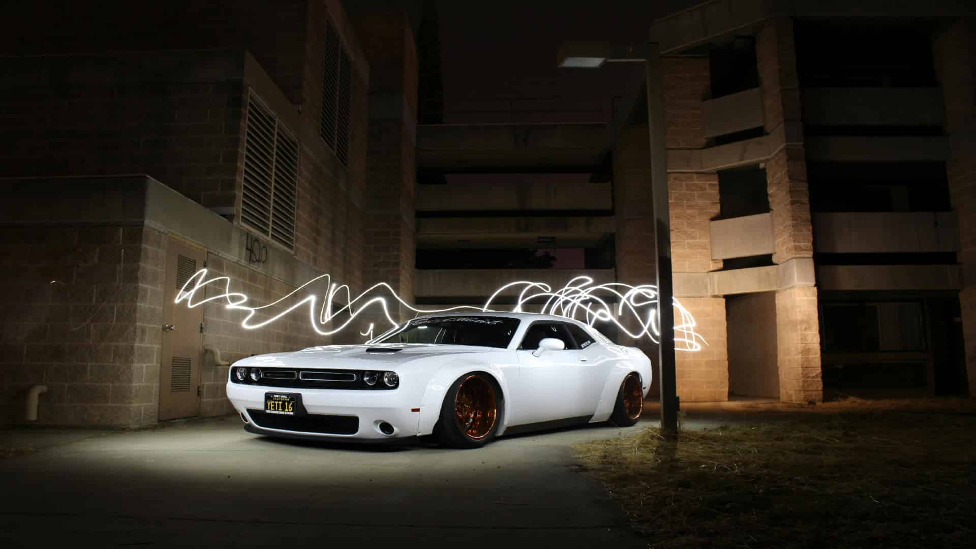 used catalytic converter buyers near me white Dodge Challenger parked at night with light trails