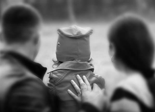 young parents and their children looking away from the camera