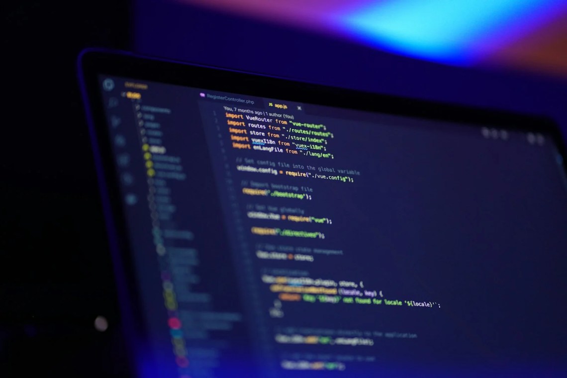 Claude Code vs Codex compared on a laptop screen displaying code