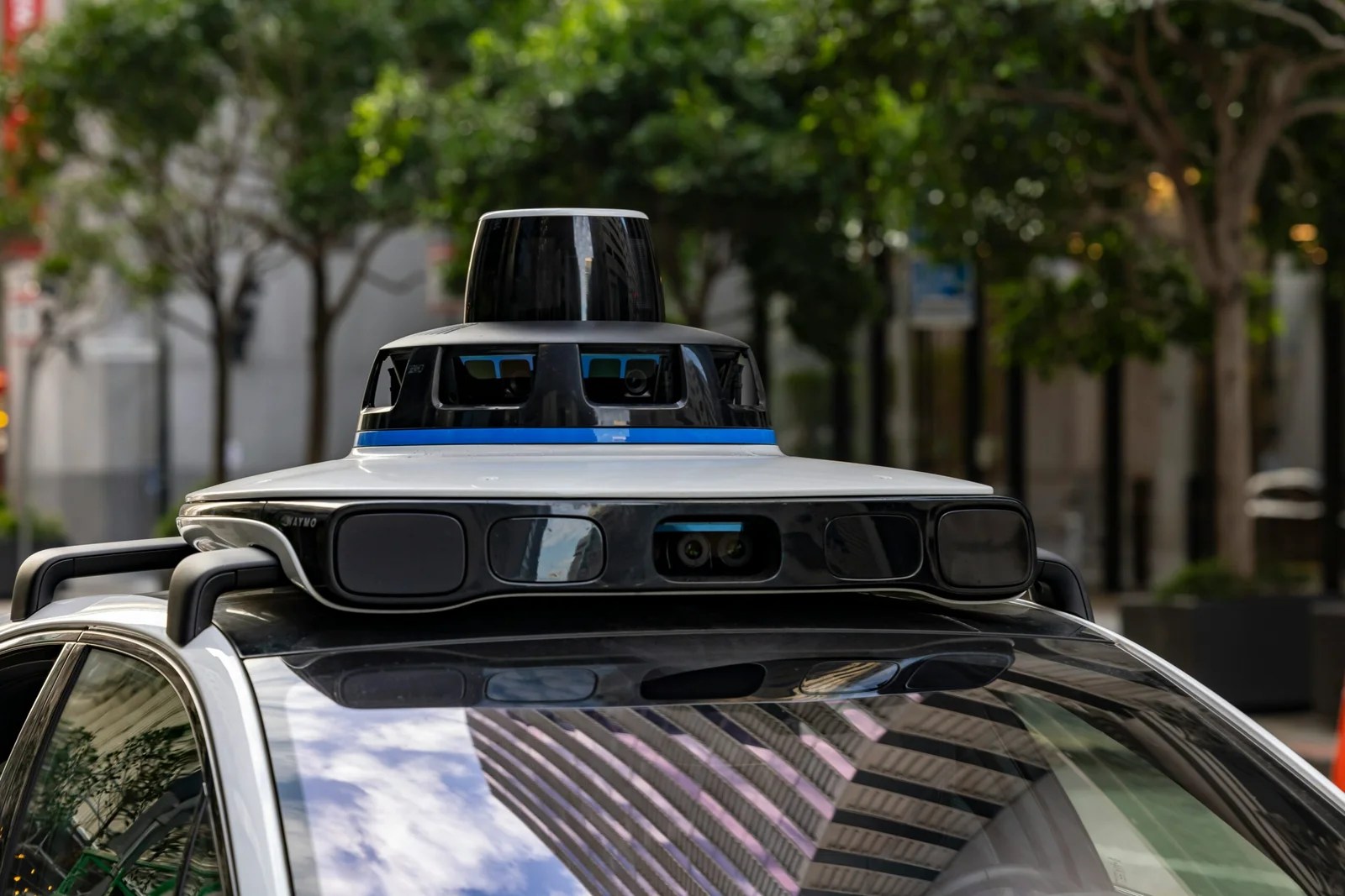 Waymo interview questions guide featuring a self-driving car with visible sensors
