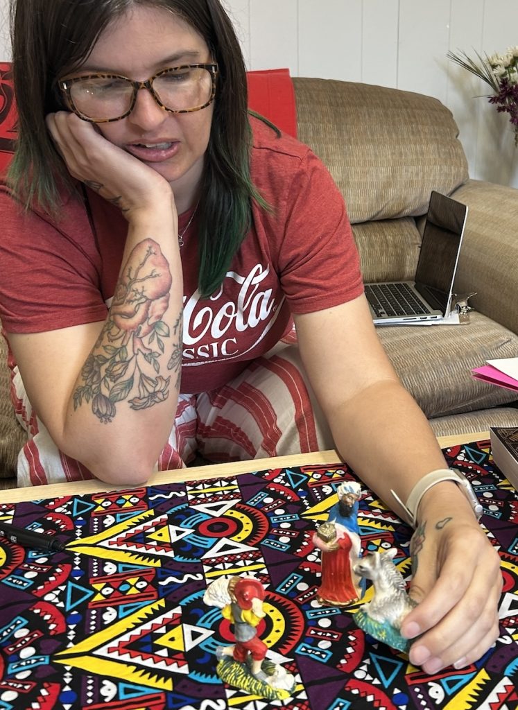 Female diaconal ministry student playing with tiny figurings on a colourful cloth