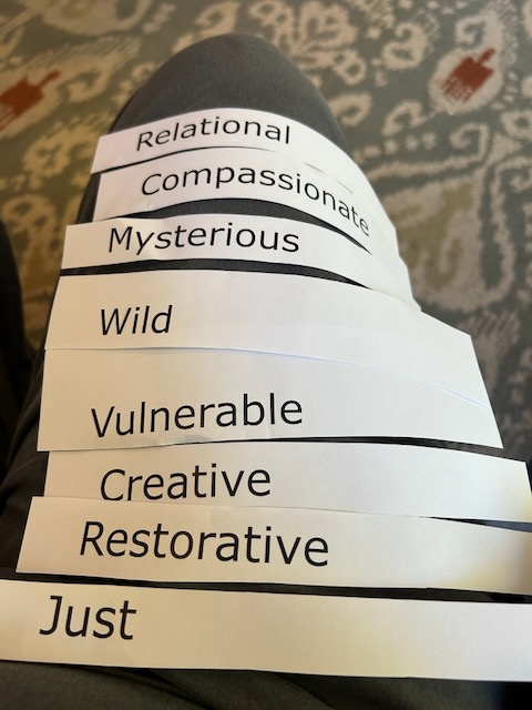 strips of paper with words like "wild", "mysterious", "relational", "just"