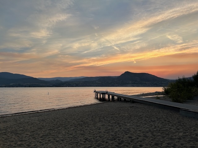 sunset over a lake with a dock