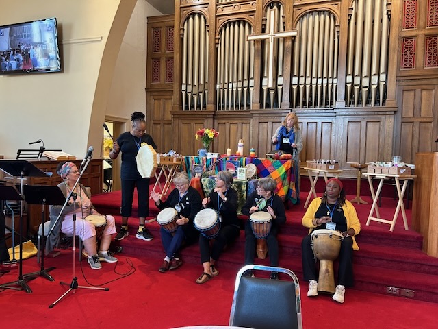 Group of people in a church sanctuary drumming