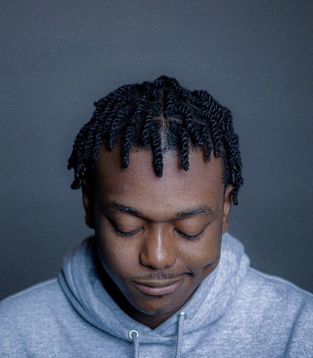 A hairstyle wherein the hair is twisted behind the head into a sort of bun style. Schedule Appointment With Blessed Roots