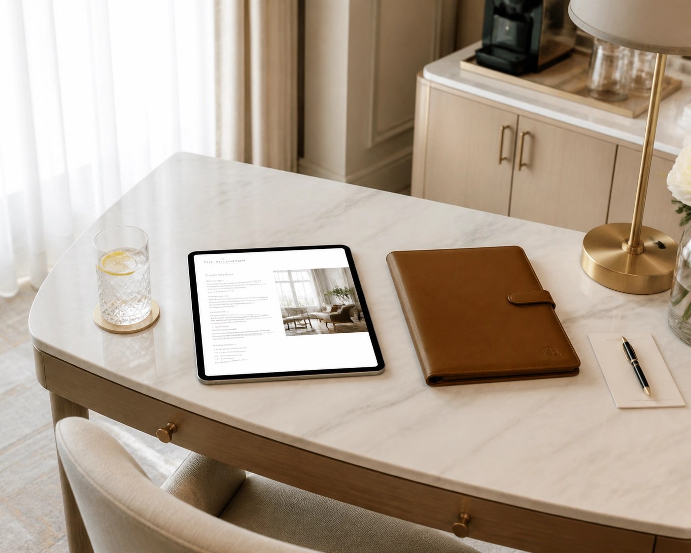 Luxury hotel suite desk with a tablet and travel documents for medical insurance coordination.