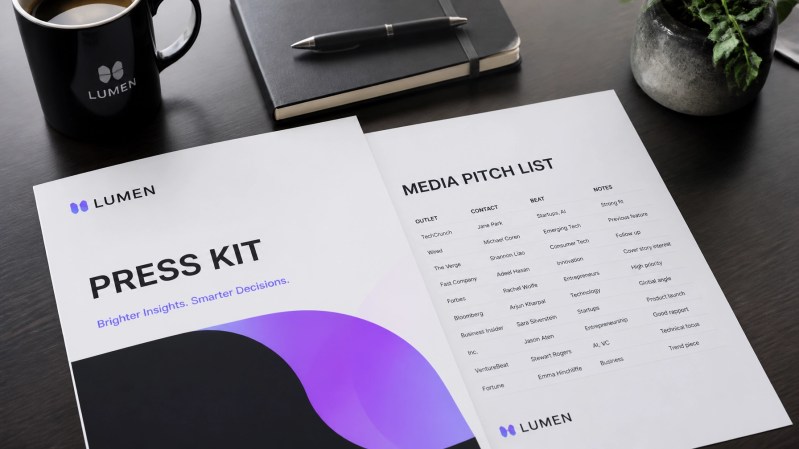 Close up of a startup press kit and media pitch list on a sleek desk