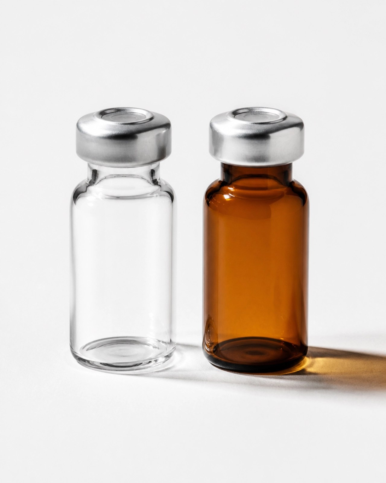 Comparison of clear and amber glass vials showing light protection