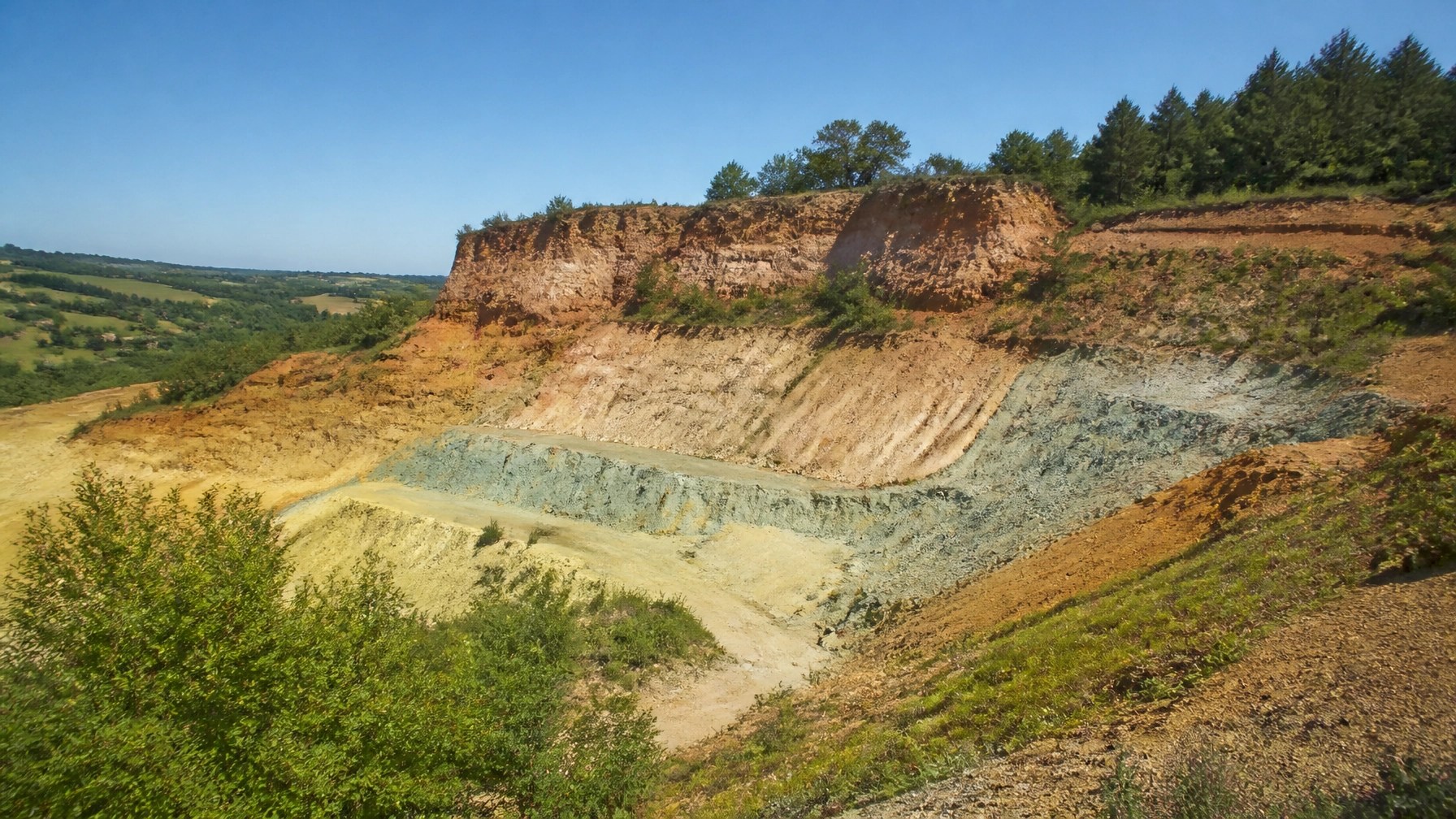 A natural green clay quarry in the French countryside