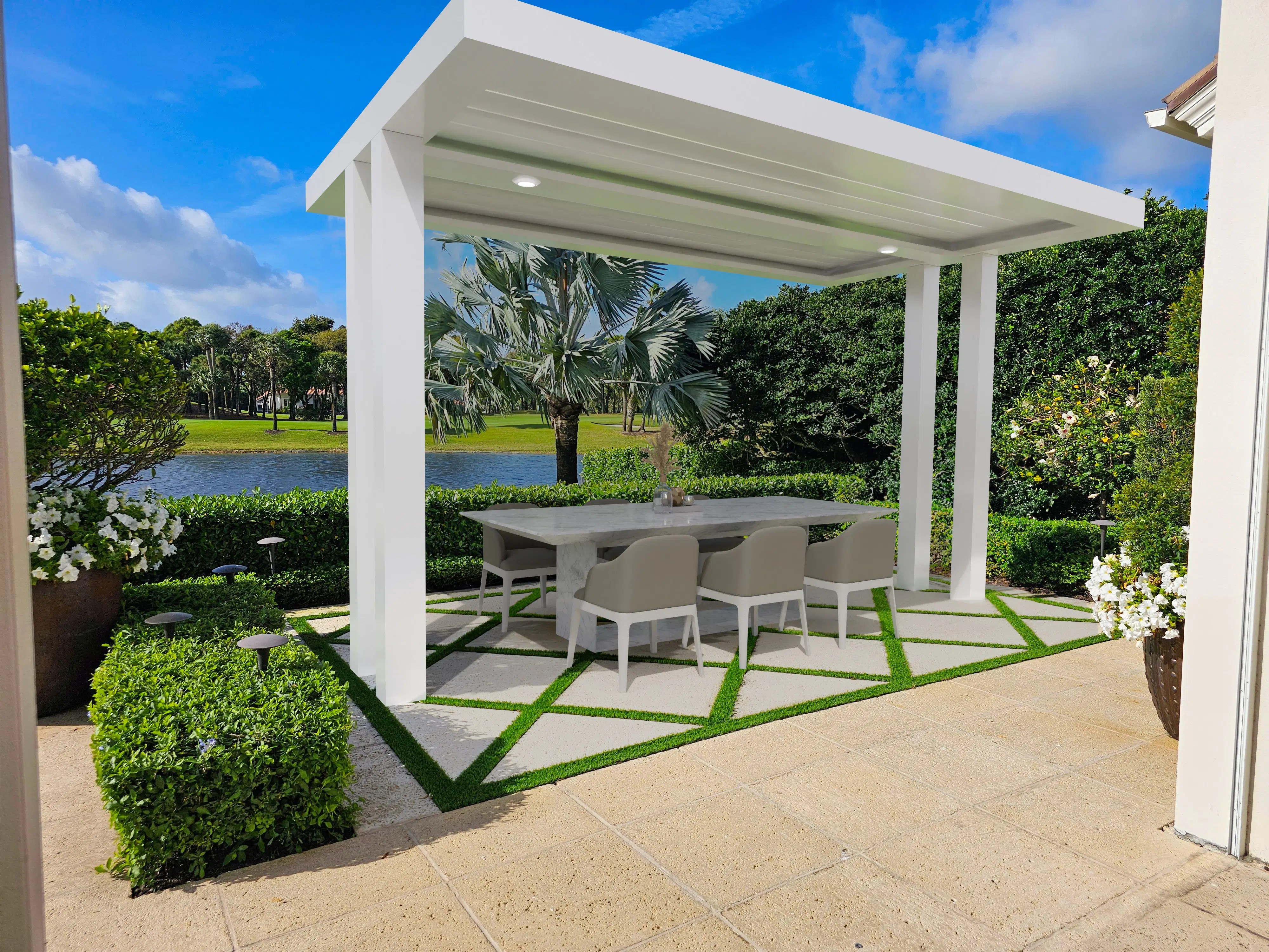 A freestanding white motorized louvered pergola set against a serene lakeside view, providing a luxurious, weather-protected dining area that defines modern outdoor elegance.