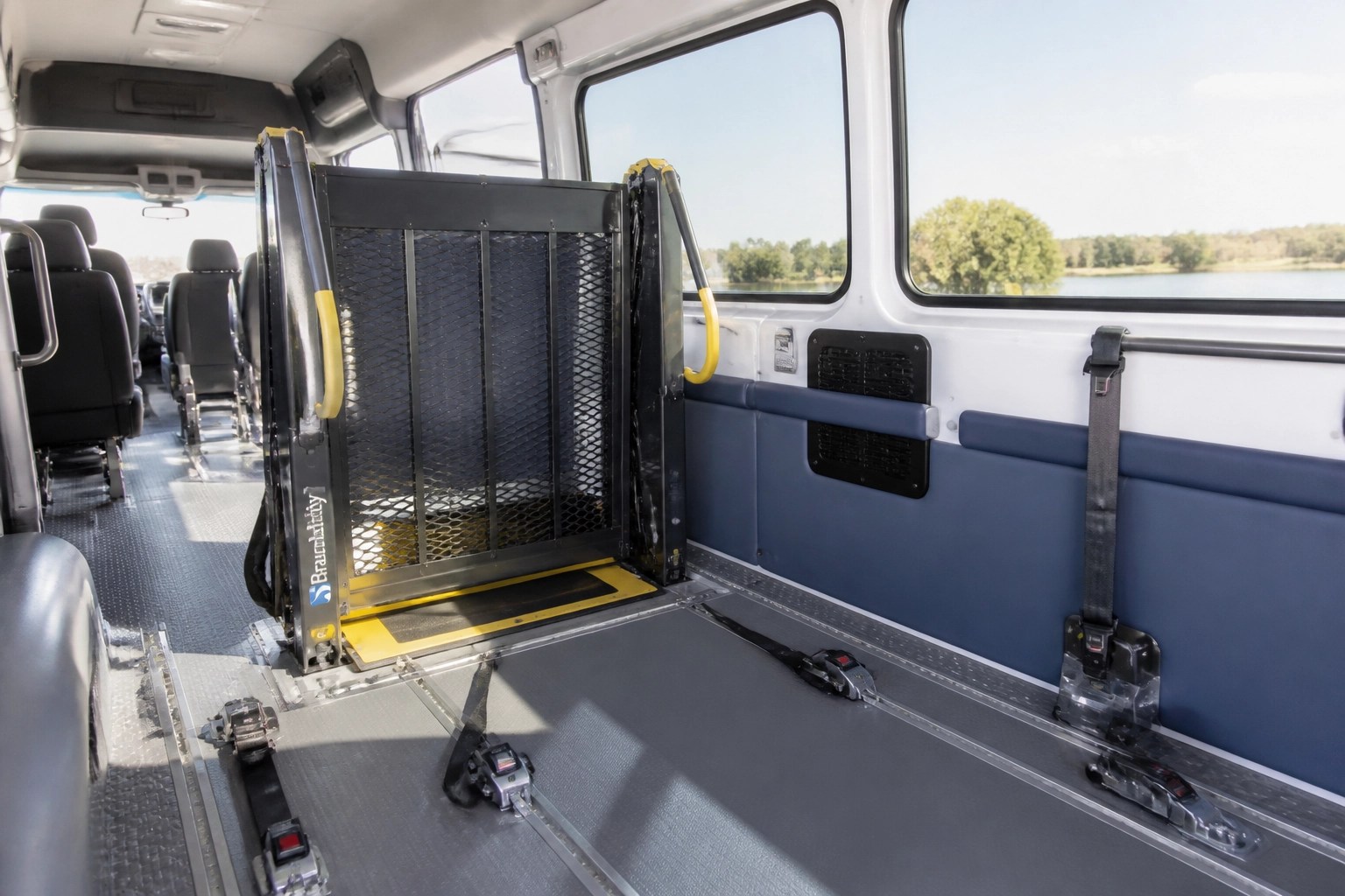 Modern interior of a wheelchair-accessible medical transport vehicle with a secure lift for rural patients.