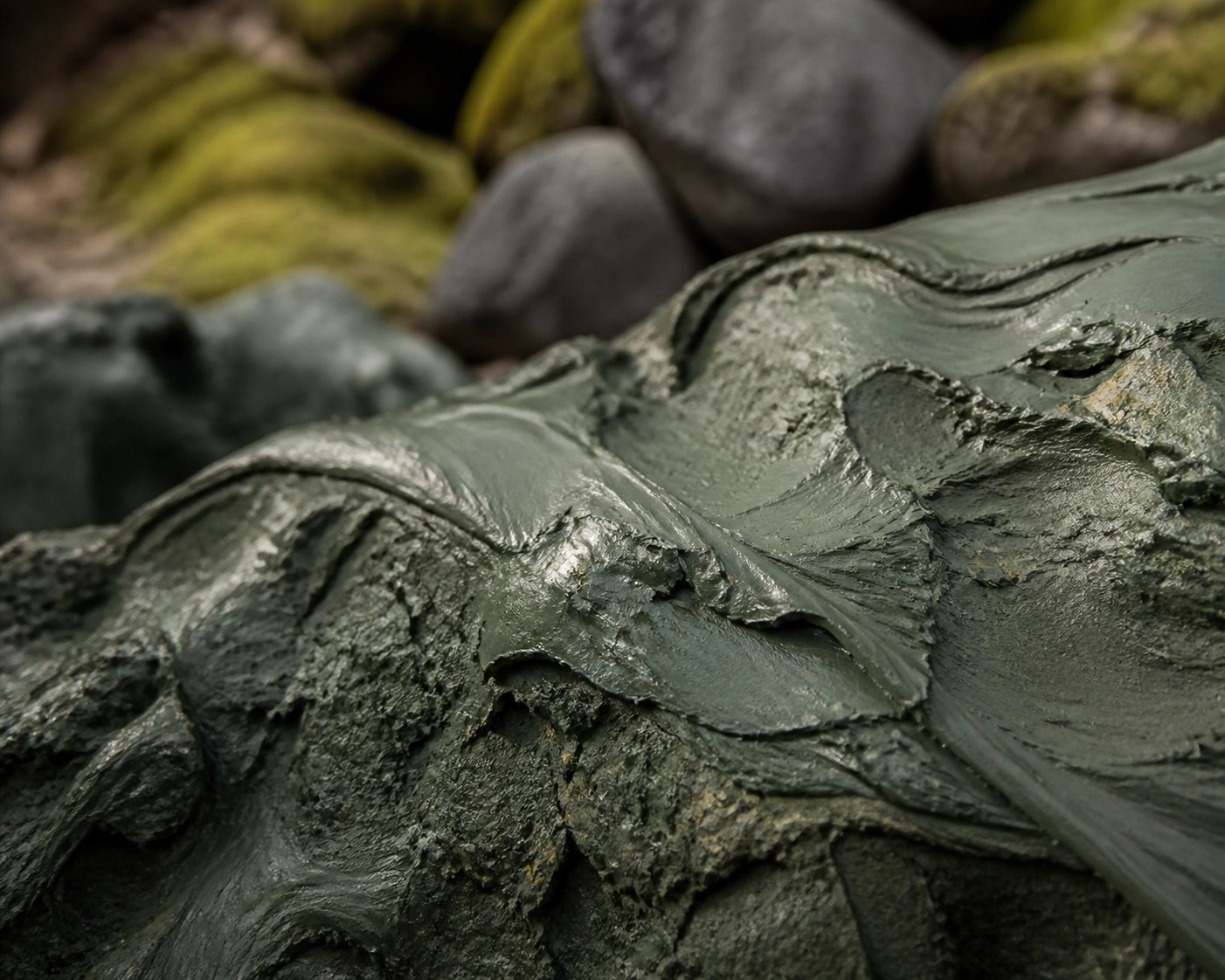 Macro view of mineral-rich raw French green clay texture for athletic recovery.