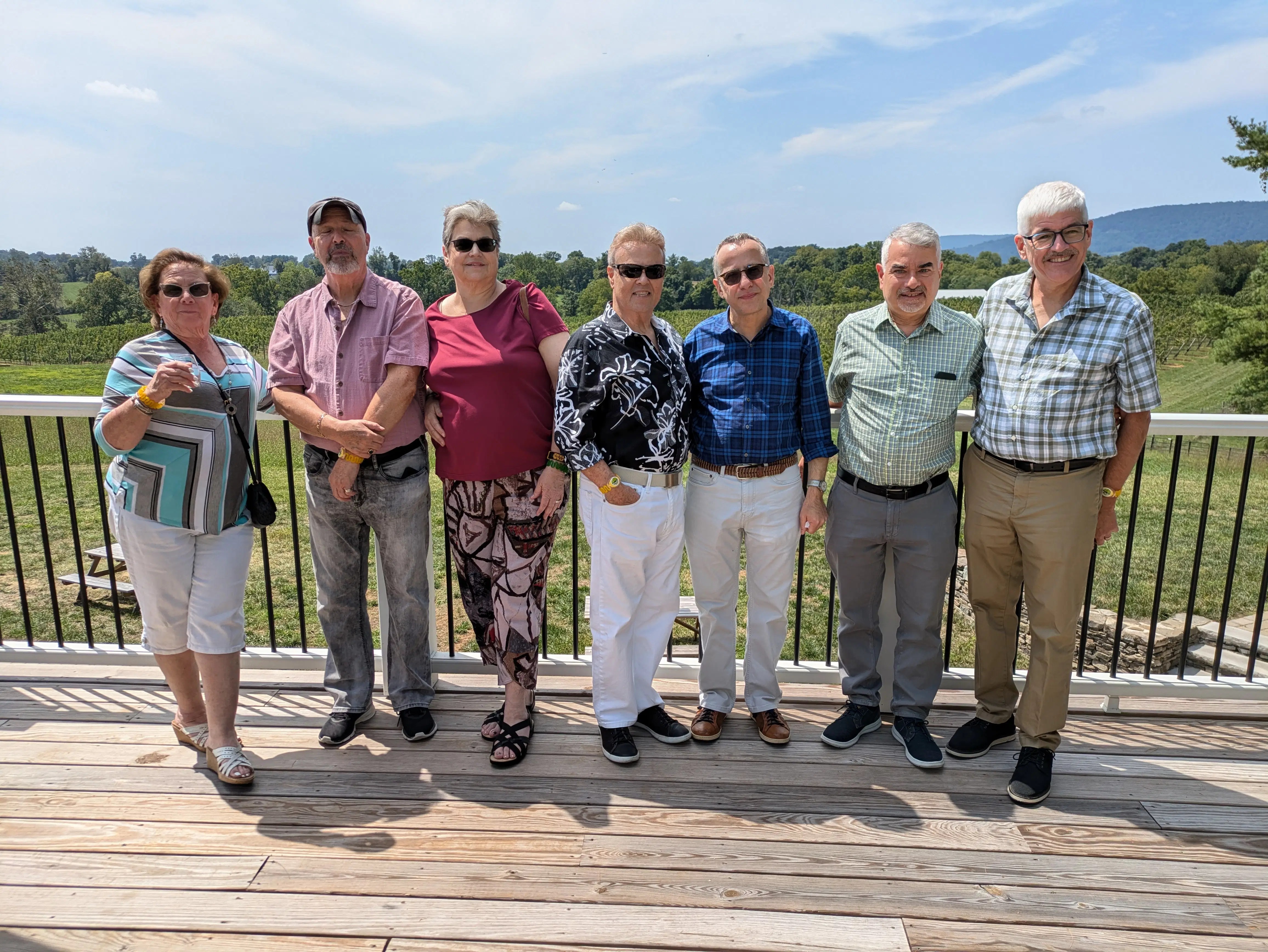 A group of friends celebrating a special occasion on an outdoor winery deck