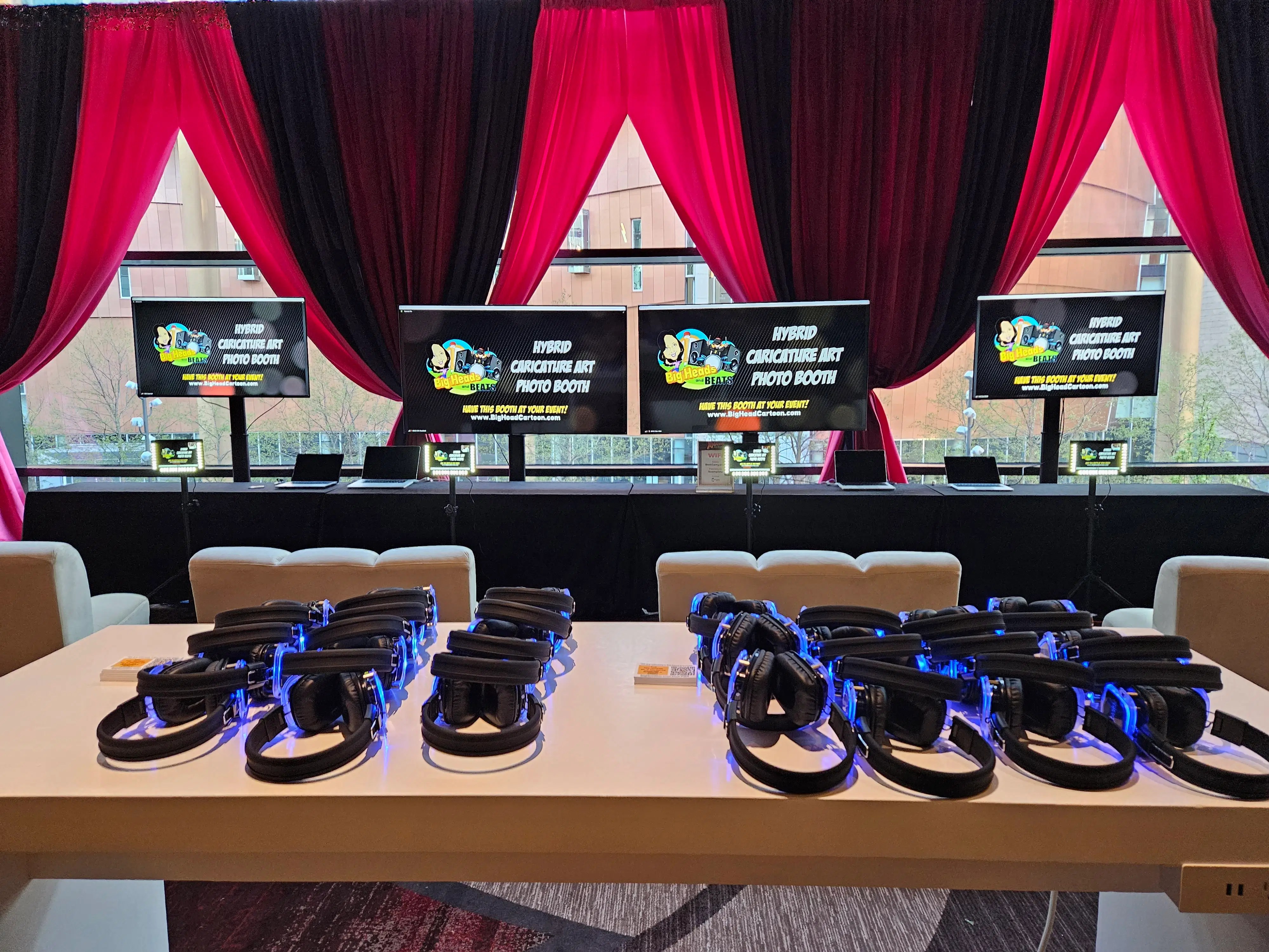 Hybrid event booth setup showing how Big Head Cartoon connects in-person attendees with remote participants through a shared digital caricature activation.