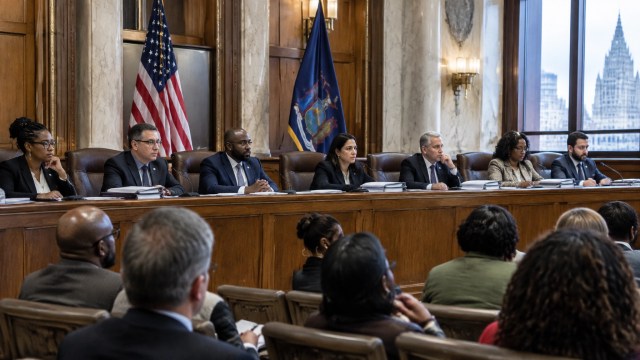 Albany Common Council members review budget documents during a public hearing