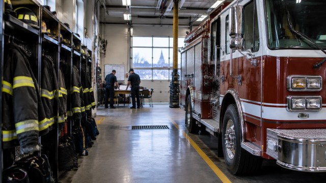 Firefighters reviewing a shift roster inside an upstate New York fire station