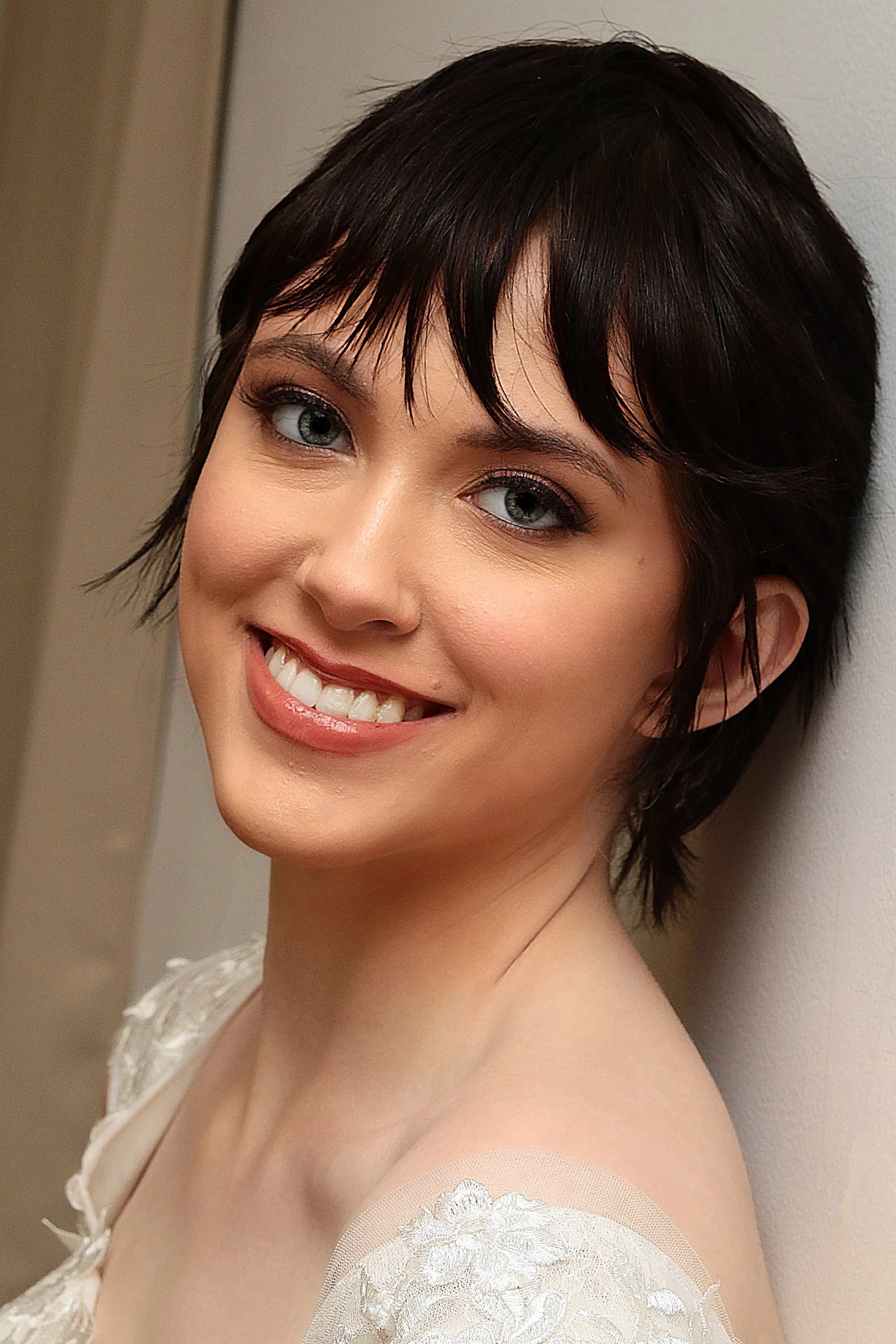 A joyful bride-to-be smiling warmly, showing off natural and elegant style