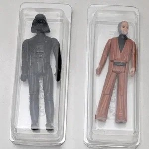 Two vintage action figures in protective plastic cases
