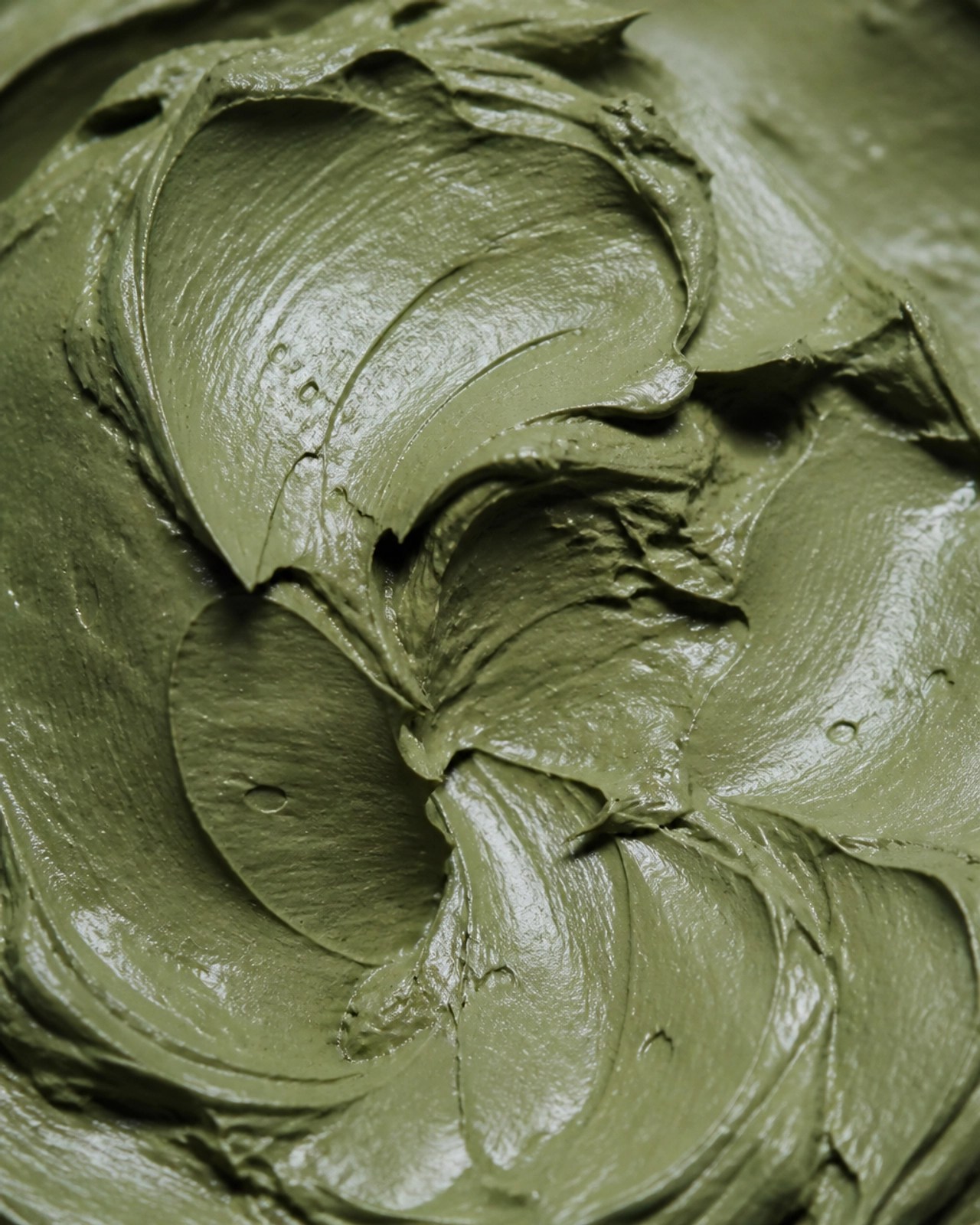Macro close-up of thick, wet green French clay texture