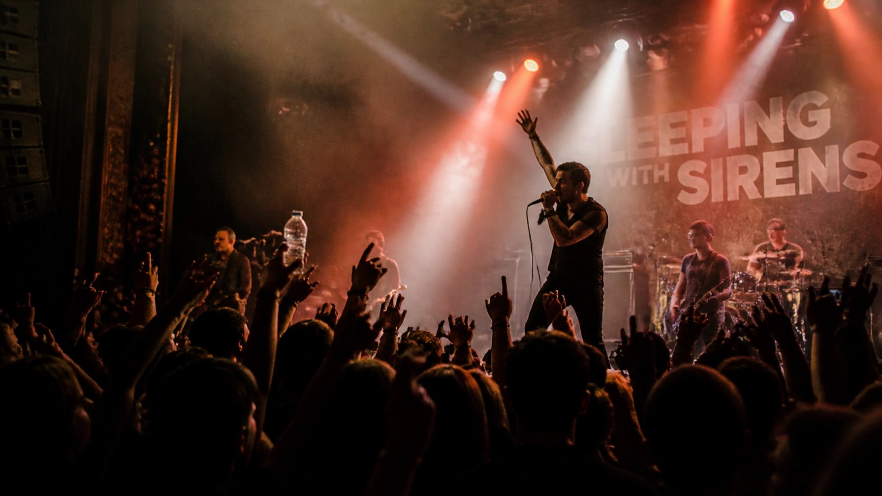 Vibrant live music concert stage with atmospheric stage lighting and a cheering crowd