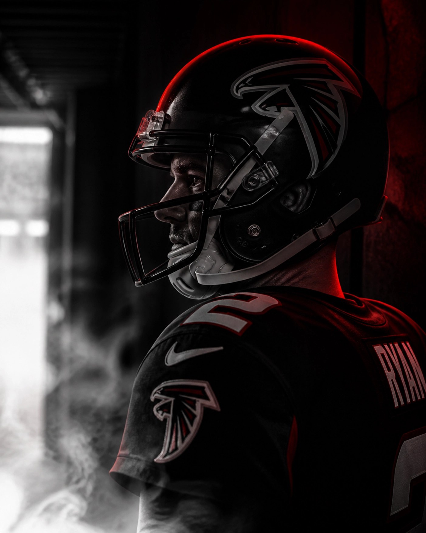 A veteran NFL quarterback in a dark stadium tunnel, representing the anticipation surrounding major team trades.