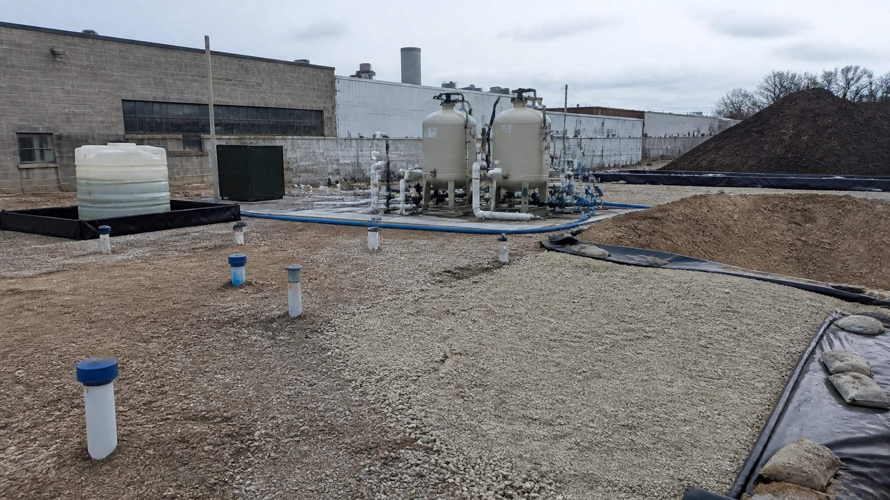 New Jersey industrial property with groundwater treatment vessels, monitoring wells, and contained soil-management area