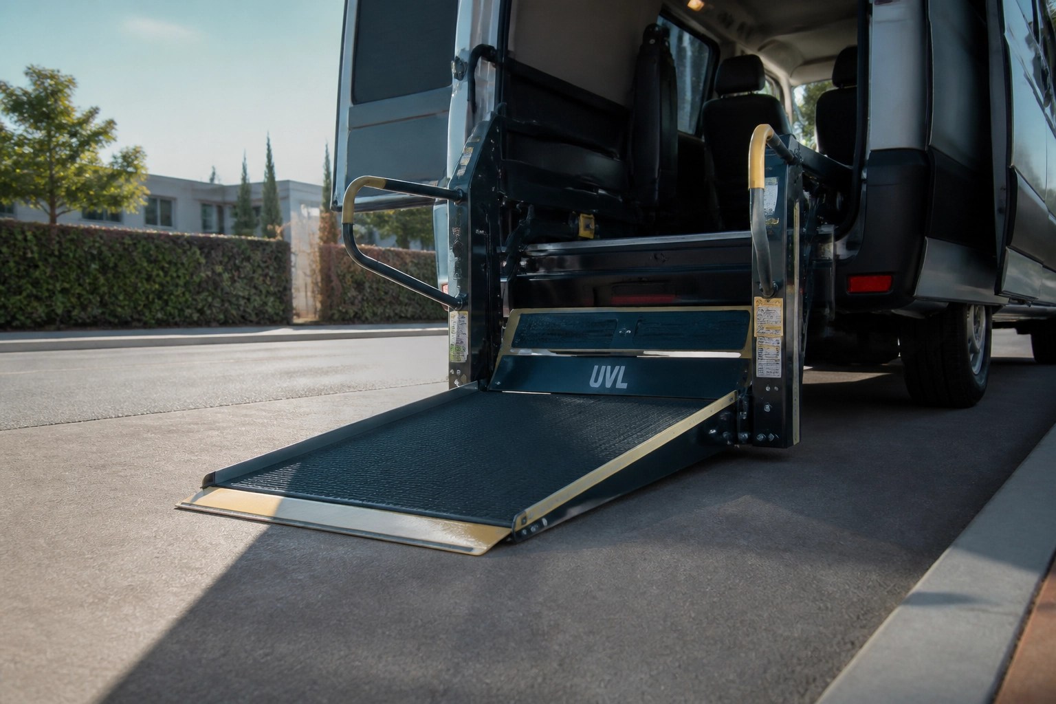Specialized hydraulic ramp on a wheelchair-accessible NEMT vehicle for safe patient boarding.