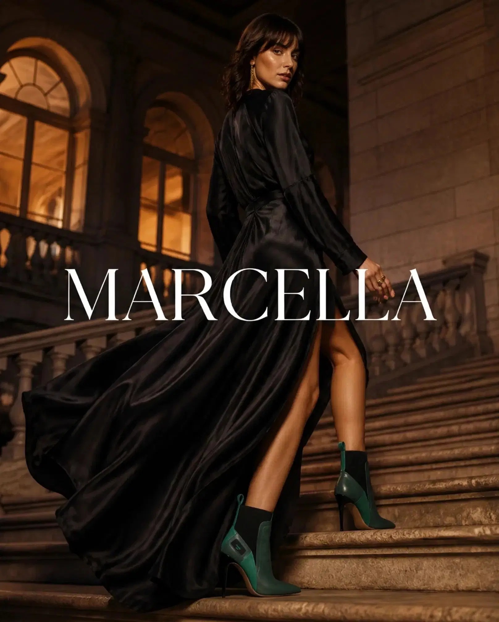 Marcella emerald and black stiletto boots styled with a flowing black gown