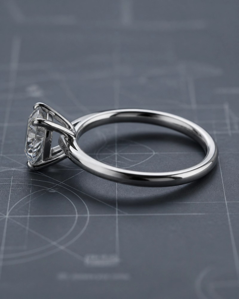 Macro side profile of engagement ring setting with prongs and gallery rail