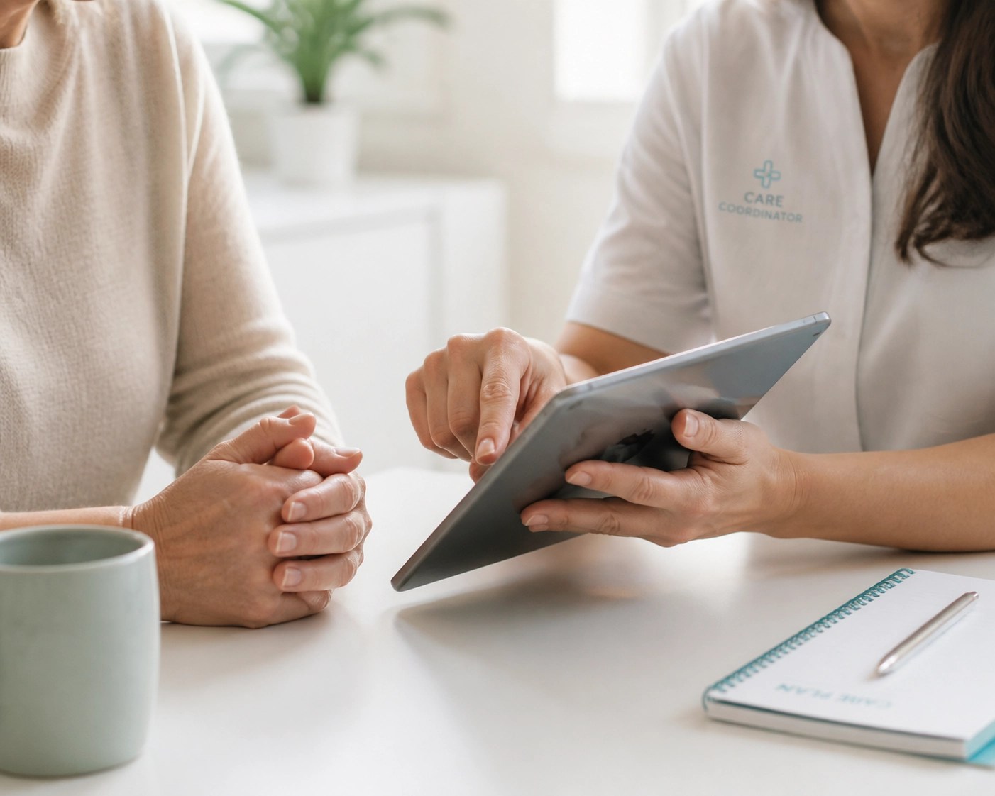 Caregiver and medical coordinator using a tablet to manage recurring dialysis ride schedules together.